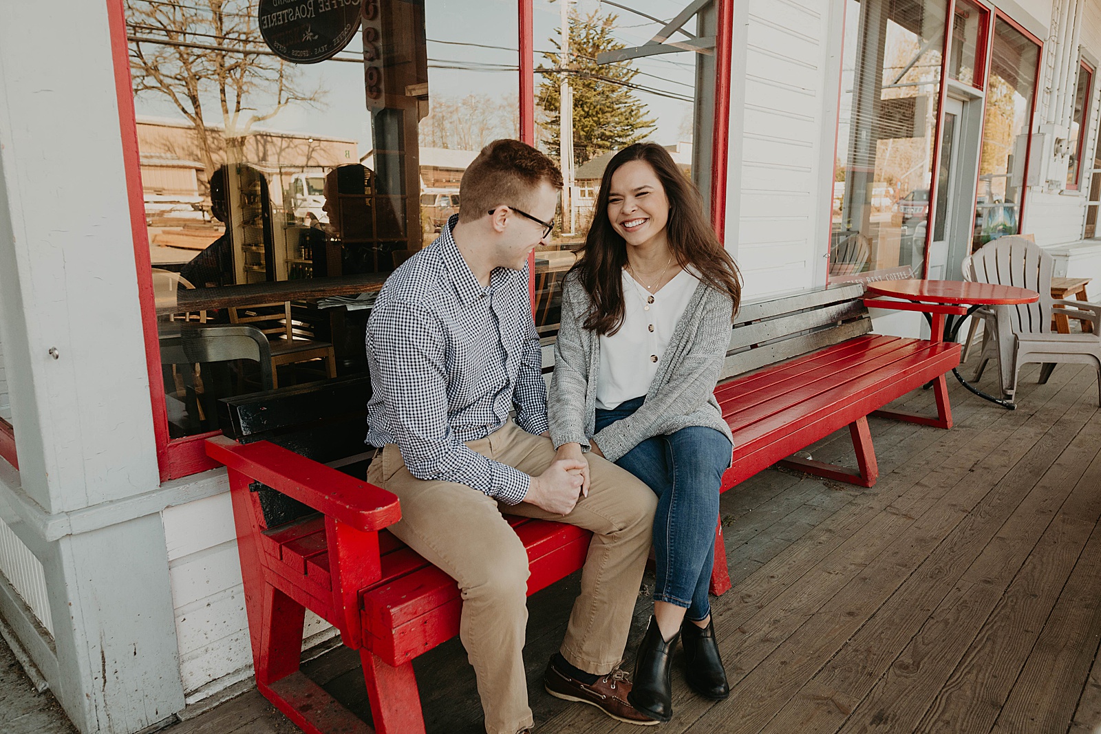 couple sitting on bench laughing